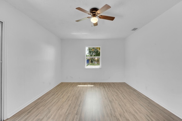 5801 SE Cable Dr, Stuart, FL 34997 - spare room with light wood finished floors and ceiling fan