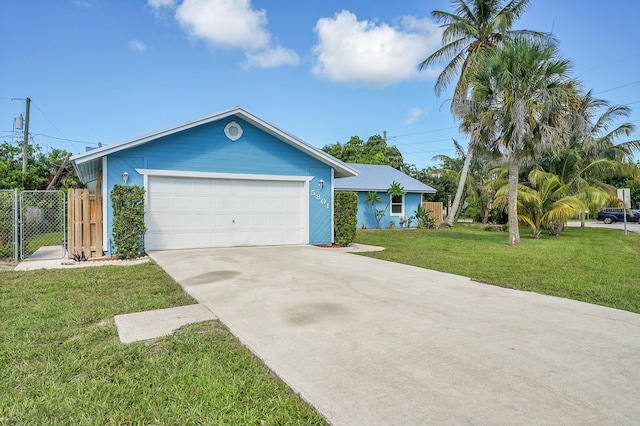 5801 SE Cable Dr, Stuart, FL 34997 - ranch-style house featuring an attached garage, driveway, and a gate