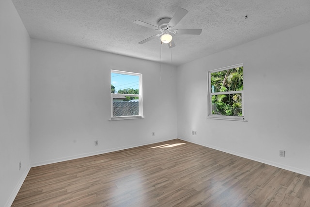 5801 SE Cable Dr, Stuart, FL 34997 - unfurnished room with wood finished floors, a textured ceiling, and ceiling fan