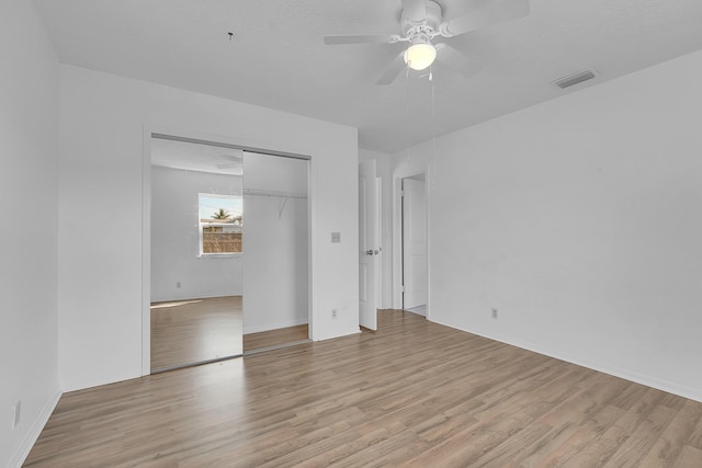 5801 SE Cable Dr, Stuart, FL 34997 - unfurnished bedroom with light wood-style flooring, a closet, and a ceiling fan