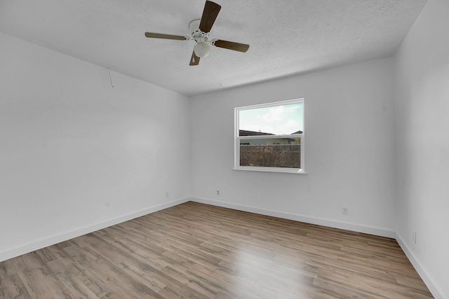 5801 SE Cable Dr, Stuart, FL 34997 - spare room featuring wood finished floors, a textured ceiling, and a ceiling fan
