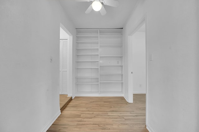 5801 SE Cable Dr, Stuart, FL 34997 - walk in closet with light wood finished floors and a ceiling fan