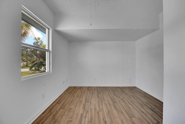 5801 SE Cable Dr, Stuart, FL 34997 - additional living space with wood finished floors and a textured ceiling