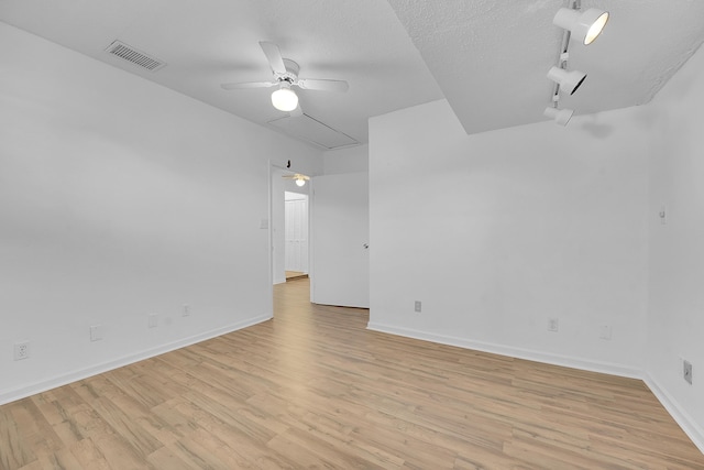 5801 SE Cable Dr, Stuart, FL 34997 - unfurnished room featuring attic access, ceiling fan, and light wood-style floors