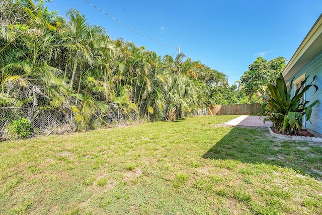 5801 SE Cable Dr, Stuart, FL 34997 - fenced backyard featuring a patio