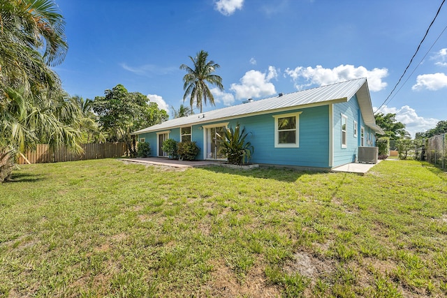 5801 SE Cable Dr, Stuart, FL 34997 - view of front of house with a fenced backyard and a metal roof