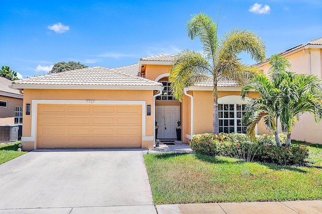 7727 Colony Lake Dr, Boynton Beach, FL 33436 - view of front facade with stucco siding, concrete driveway, a garage, a tile roof, and a front yard