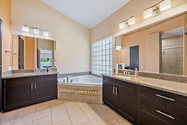 7727 Colony Lake Dr, Boynton Beach, FL 33436 - full bath featuring a garden tub, tile patterned flooring, two vanities, a stall shower, and vaulted ceiling