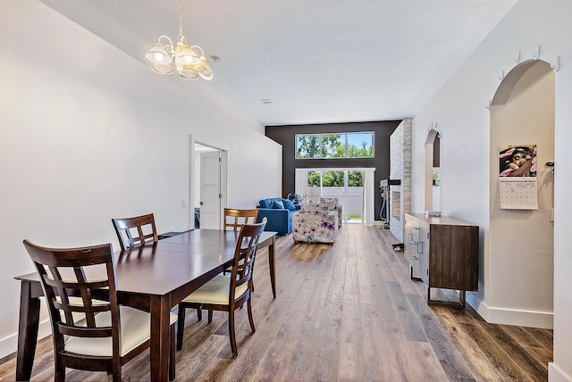 7727 Colony Lake Dr, Boynton Beach, FL 33436 - dining space with dark wood-type flooring, a chandelier, and arched walkways