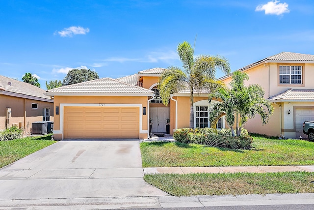 7727 Colony Lake Dr, Boynton Beach, FL 33436 - view of front facade with stucco siding, an attached garage, driveway, a tiled roof, and a front yard