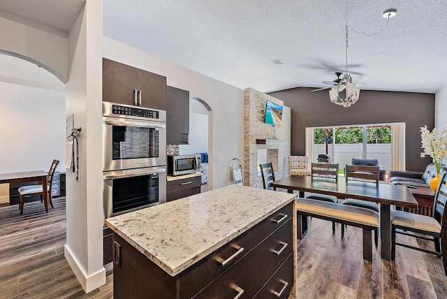 7727 Colony Lake Dr, Boynton Beach, FL 33436 - kitchen with appliances with stainless steel finishes, arched walkways, lofted ceiling, open floor plan, and ceiling fan