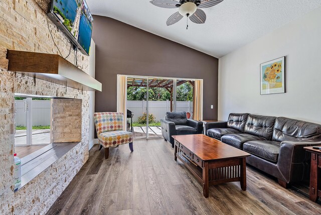 7727 Colony Lake Dr, Boynton Beach, FL 33436 - living area with wood finished floors, a ceiling fan, high vaulted ceiling, and a fireplace