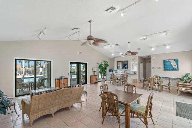 7782 Stirling Bridge Blvd S, Delray Beach, FL 33446 - dining room featuring rail lighting, a ceiling fan, light tile patterned flooring, vaulted ceiling, and a textured ceiling