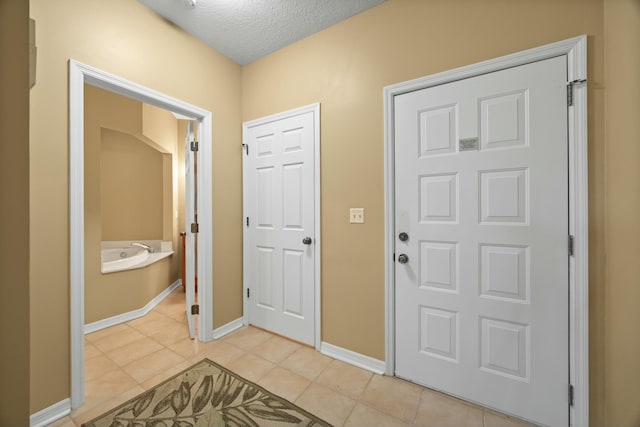 9894 Perfect Dr Unit 21, Port Saint Lucie, FL 34986 - entrance foyer with light tile patterned flooring and a textured ceiling