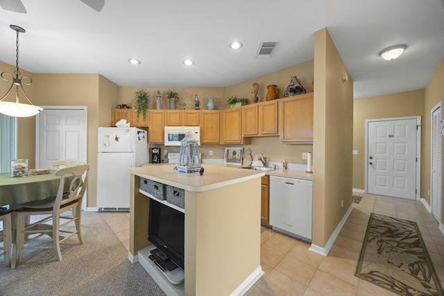 9894 Perfect Dr Unit 21, Port Saint Lucie, FL 34986 - kitchen featuring white appliances, light countertops, light tile patterned flooring, a kitchen island, and recessed lighting