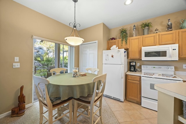 9894 Perfect Dr Unit 21, Port Saint Lucie, FL 34986 - kitchen with white appliances, light countertops, and decorative light fixtures