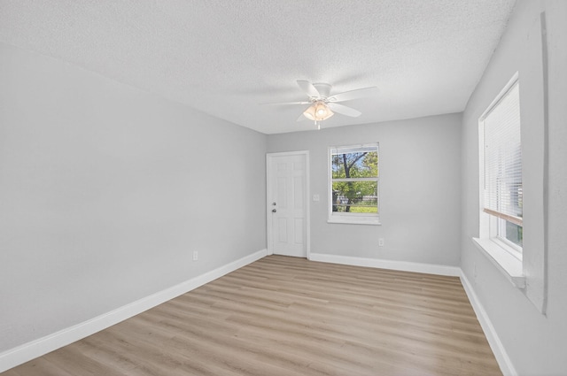 323 S E St, Lake Worth Beach, FL 33460 - unfurnished room featuring a textured ceiling, light wood-style flooring, and ceiling fan