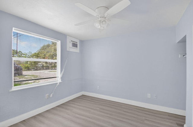 323 S E St, Lake Worth Beach, FL 33460 - unfurnished room featuring wood finished floors, ceiling fan, and a wall unit AC