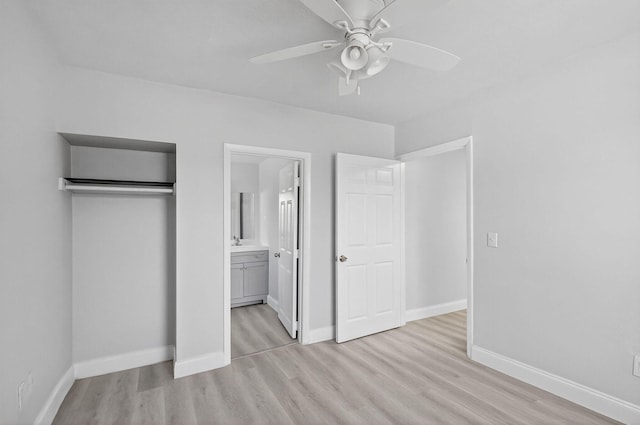 323 S E St, Lake Worth Beach, FL 33460 - unfurnished bedroom with light wood finished floors, ensuite bath, a closet, and a ceiling fan