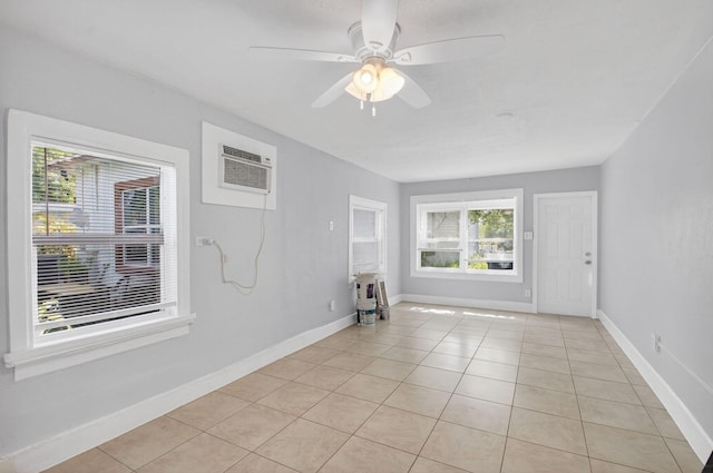 323 S E St, Lake Worth Beach, FL 33460 - unfurnished room with healthy amount of natural light, a wall mounted air conditioner, light tile patterned flooring, and ceiling fan