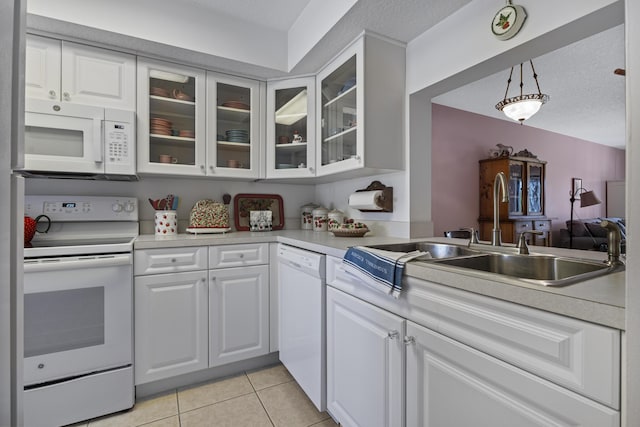 4215 Gator Trace Ave Unit I, Fort Pierce, FL 34950 - kitchen featuring white appliances, light tile patterned flooring, glass insert cabinets, light countertops, and white cabinetry