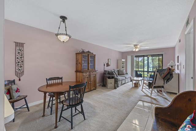 4215 Gator Trace Ave Unit I, Fort Pierce, FL 34950 - dining space featuring a textured ceiling, light colored carpet, ceiling fan, and light tile patterned floors