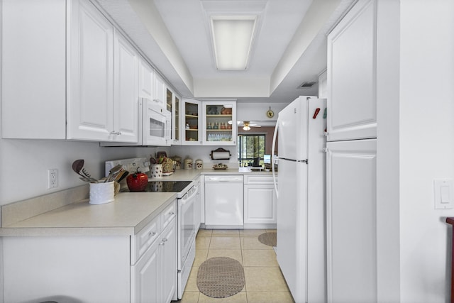 4215 Gator Trace Ave Unit I, Fort Pierce, FL 34950 - kitchen with white appliances, white cabinetry, glass insert cabinets, light countertops, and light tile patterned floors