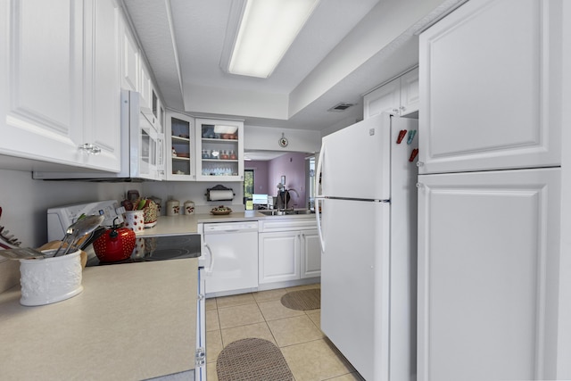 4215 Gator Trace Ave Unit I, Fort Pierce, FL 34950 - kitchen featuring white appliances, white cabinetry, light countertops, and glass insert cabinets