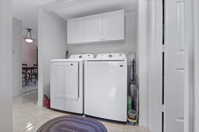 4215 Gator Trace Ave Unit I, Fort Pierce, FL 34950 - washroom with washing machine and dryer, light tile patterned floors, and cabinet space
