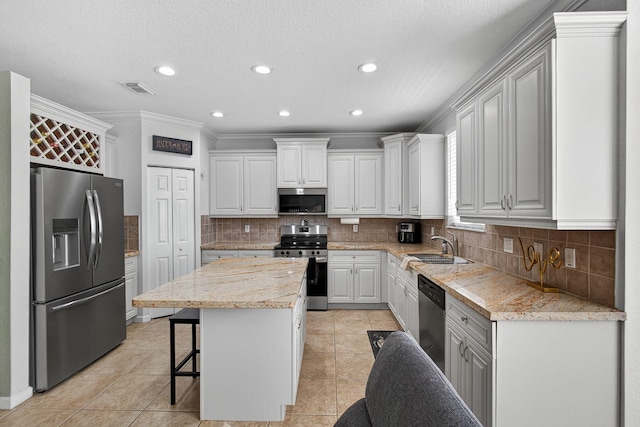 3004 N Evergreen Cir, Boynton Beach, FL 33426 - kitchen with stainless steel appliances, light tile patterned floors, a center island, recessed lighting, and ornamental molding
