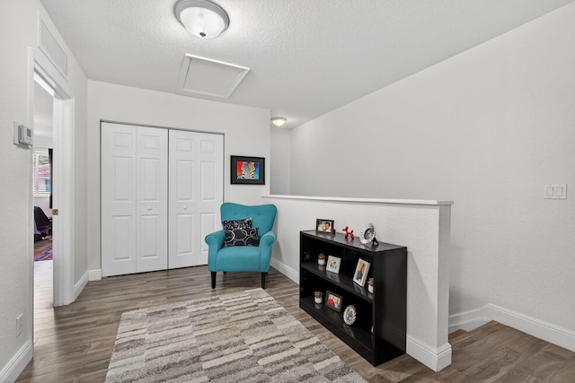 3004 N Evergreen Cir, Boynton Beach, FL 33426 - living area with attic access, wood finished floors, and a textured ceiling