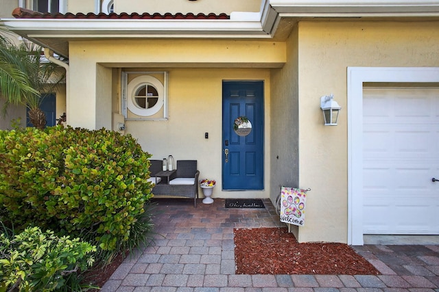3004 N Evergreen Cir, Boynton Beach, FL 33426 - doorway to property with stucco siding and a garage
