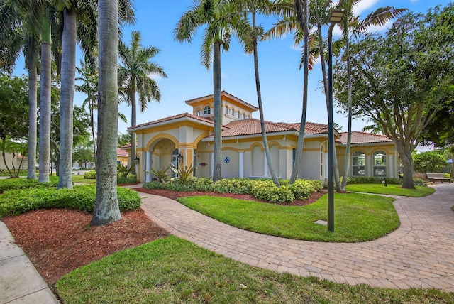 3004 N Evergreen Cir, Boynton Beach, FL 33426 - mediterranean / spanish-style home with a tile roof, stucco siding, and a front yard