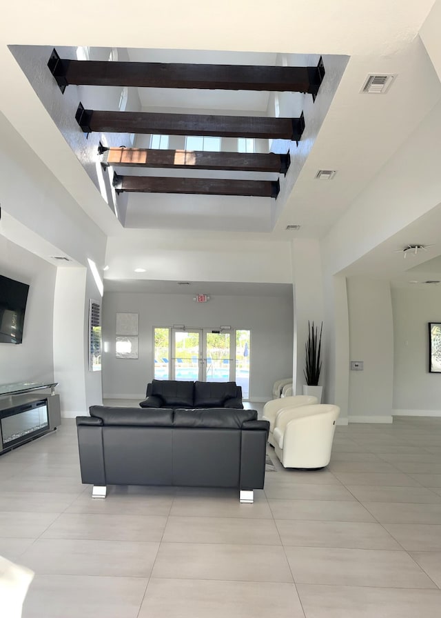 3004 N Evergreen Cir, Boynton Beach, FL 33426 - living area with light tile patterned floors, a high ceiling, and a glass covered fireplace