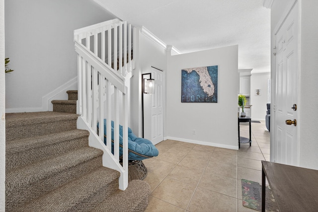 3004 N Evergreen Cir, Boynton Beach, FL 33426 - foyer entrance with light tile patterned flooring, stairway, and ornamental molding