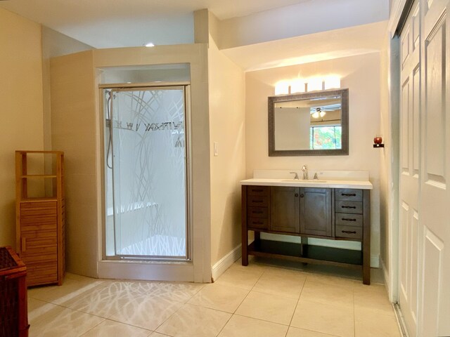 16651 96th Ter N, Jupiter, FL 33478 - full bathroom featuring vanity, tile patterned floors, and a stall shower