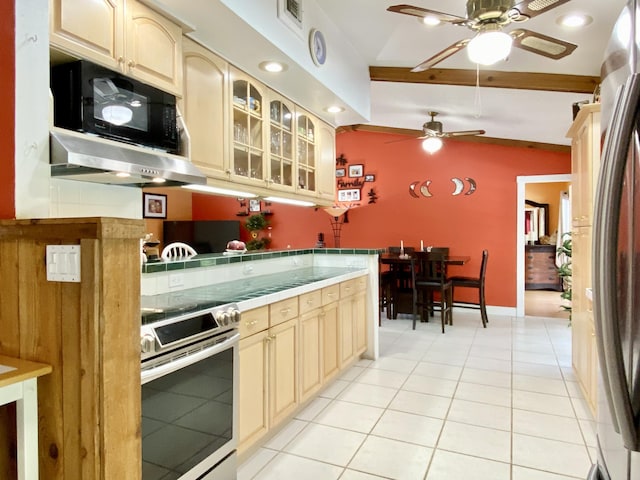 16651 96th Ter N, Jupiter, FL 33478 - kitchen featuring stainless steel range with electric cooktop, ceiling fan, under cabinet range hood, cream cabinets, and light tile patterned floors