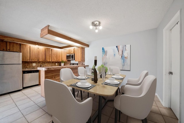 2897 SW 22nd Cir Unit 44B, Delray Beach, FL 33445 - dining room featuring light tile patterned floors and a textured ceiling