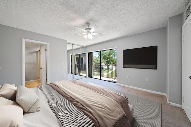 2897 SW 22nd Cir Unit 44B, Delray Beach, FL 33445 - bedroom featuring access to exterior, connected bathroom, ceiling fan, and light carpet
