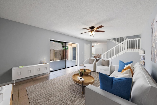 2897 SW 22nd Cir Unit 44B, Delray Beach, FL 33445 - living area with stairs, a ceiling fan, tile patterned floors, and a textured ceiling