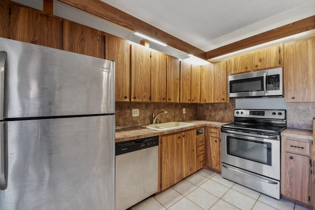 2897 SW 22nd Cir Unit 44B, Delray Beach, FL 33445 - kitchen with stainless steel appliances, light tile patterned floors, backsplash, light countertops, and a textured ceiling