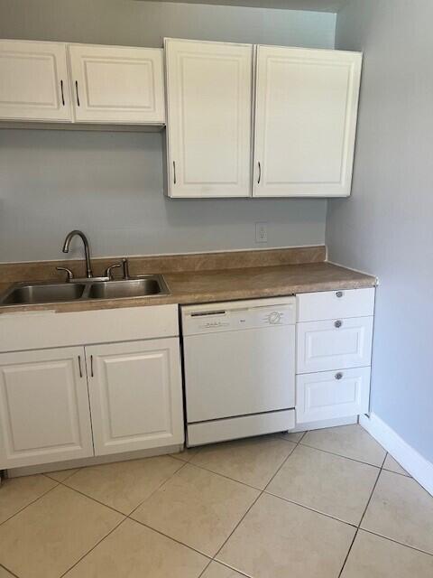 1829 N A St Unit 74, Lake Worth, FL 33460 - kitchen with white dishwasher, white cabinets, and light tile patterned floors