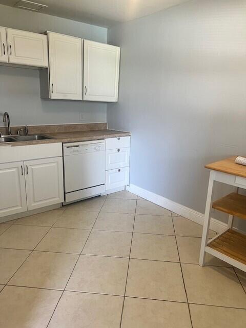 1829 N A St Unit 74, Lake Worth, FL 33460 - kitchen featuring dishwasher, white cabinetry, and light tile patterned floors