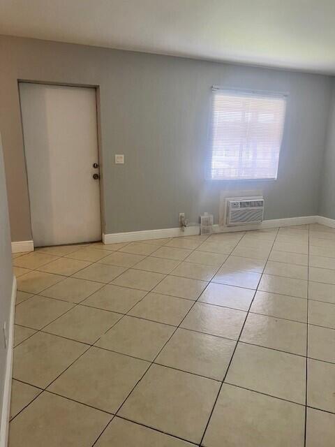 1829 N A St Unit 74, Lake Worth, FL 33460 - spare room with light tile patterned floors and a wall unit AC