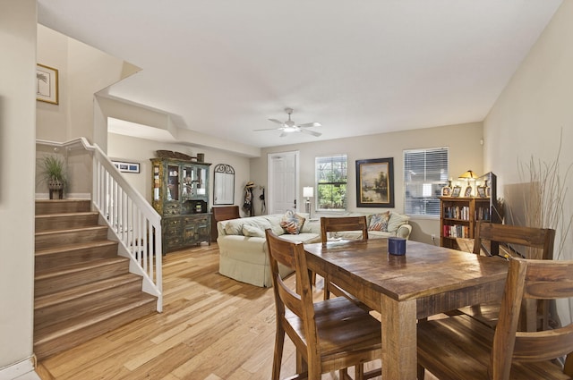 3032 W Community Dr, Jupiter, FL 33458 - dining area featuring a ceiling fan, light wood finished floors, and stairway