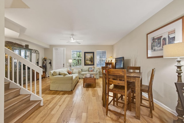 3032 W Community Dr, Jupiter, FL 33458 - living area with light wood-type flooring, ceiling fan, and stairs