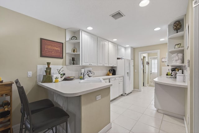 3032 W Community Dr, Jupiter, FL 33458 - kitchen featuring open shelves, white appliances, tasteful backsplash, a peninsula, and light countertops