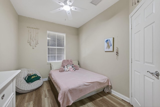 3032 W Community Dr, Jupiter, FL 33458 - bedroom featuring wood finished floors and a ceiling fan