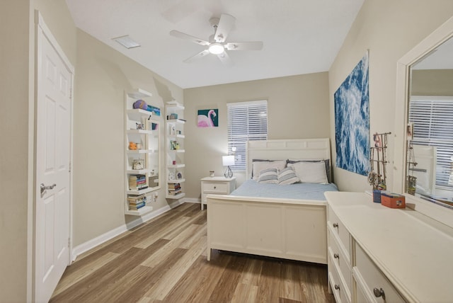 3032 W Community Dr, Jupiter, FL 33458 - bedroom featuring light wood finished floors and ceiling fan