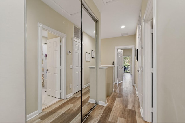 3032 W Community Dr, Jupiter, FL 33458 - hall featuring attic access, light wood finished floors, and recessed lighting